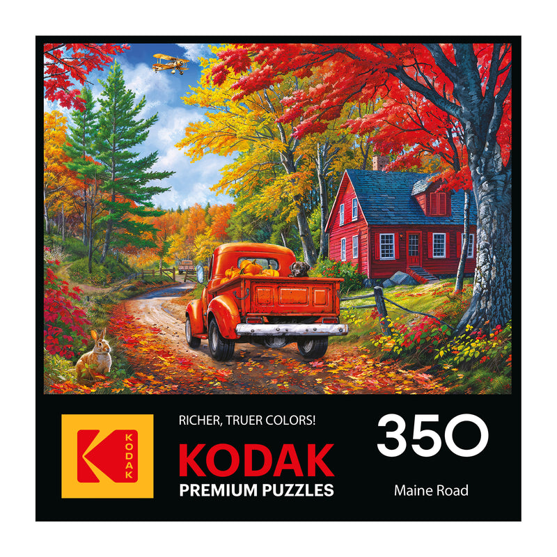 A red vintage truck drives by a red house amid colorful fall trees as a rabbit sits nearby. The box says "ROSEART - KODAK PREMIUM - MAINE ROAD - 350 PIECE JIGSAW PUZZLE.