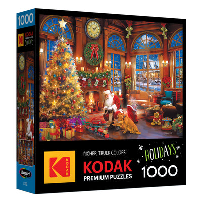 Celebrate the holidays with the ROSEART - KODAK PREMIUM CHRISTMAS MAGIC 1000 piece jigsaw puzzle, featuring a festive living room scene with Santa, a Christmas tree, gifts, a fireplace, and a dog.