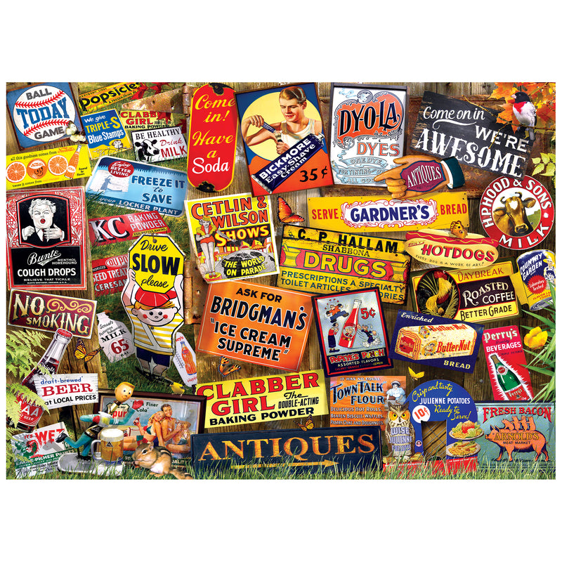 The ROSEART KODAK CORK ANTIQUE SIGNS 1000-piece jigsaw puzzle features a collage of vintage product signs, including soda, dyes, bread, and medicines, set against a grassy background with autumn leaves for a nostalgic touch.