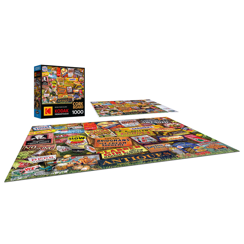 The ROSEART KODAK CORK ANTIQUE SIGNS 1000-piece jigsaw puzzle features a vivid collage of vintage signs and ads, displayed finished beside its box.