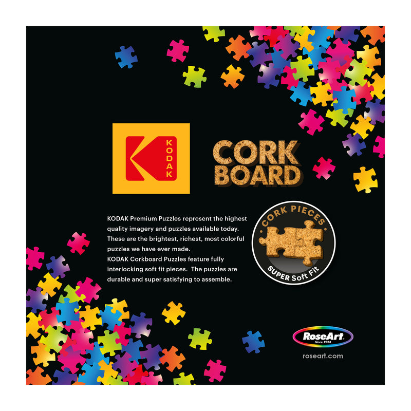 The ROSEART - KODAK CORK - THE COFFEE SHOP 1000 piece jigsaw puzzle features colorful cork pieces, Kodak logo, “Cork Pieces” badge, and RoseArt branding—premium quality and perfect for coffee shop gatherings.