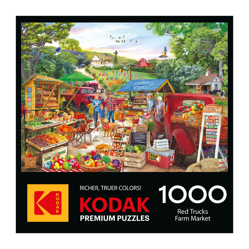 The ROSEART KODAK PREMIUM RED TRUCKS FARM MARKET 1000 Piece Jigsaw Puzzle box shows a vibrant rural farm market with red trucks, produce stands, and shoppers. Text highlights the product name and piece count.