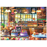 Bright bakery with cakes, cupcakes, pastries, and ice cream in the sunlight—THE BAKERY 1000 Piece Jigsaw Puzzle from ROSEART KODAK PREMIUM is a sweet challenge for puzzle fans.