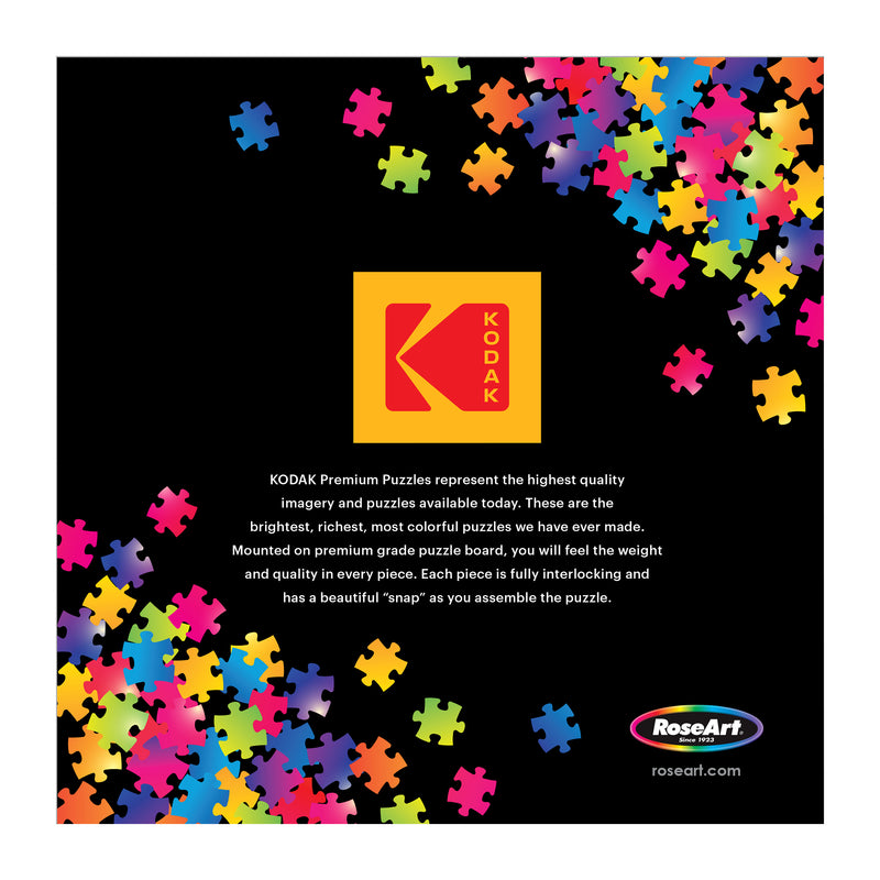 Colorful puzzle pieces surround a black square with the Kodak logo, highlighting the ROSEART - KODAK PREMIUM - THE BAKERY 1000 Piece Jigsaw Puzzle—a delightful puzzle for all ages.