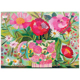 The ROSEART-SOFT TOUCH-CUP FULL OF ROSIE-1000 PIECE JIGSAW PUZZLE features a vibrant vase with pink and red flowers, green leaves, and blossoms on a light blue background for a delightful puzzling experience.