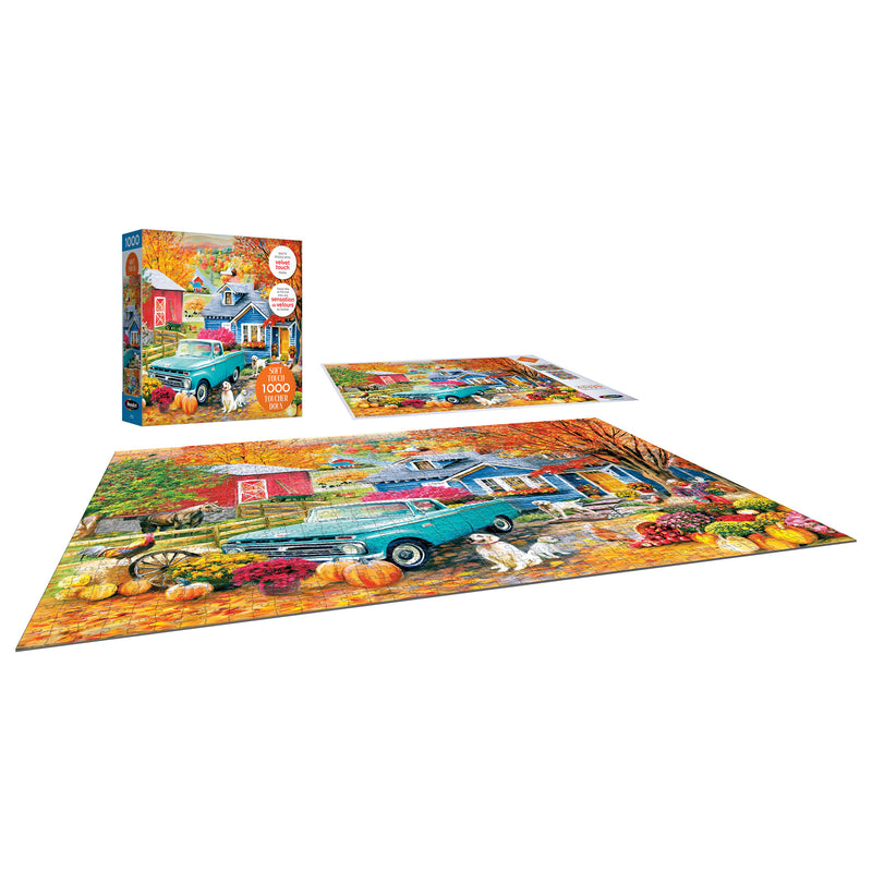 A completed ROSEART-SOFT TOUCH-AUTUMN HILL COTTAGE 1000 piece jigsaw puzzle and box, featuring a turquoise truck, pumpkins, colorful leaves, and the picturesque Autumn Hill Cottage in an autumn scene.