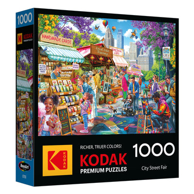 The ROSEART-KODAK PREMIUM-CITY STREET FAIR 1000-piece jigsaw puzzle features a vibrant illustration of vendors, shoppers, and children in a lively city park street fair setting.