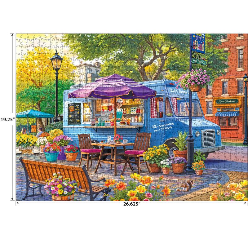 The ROSEART-KODAK PREMIUM CITY FOOD TRUCK 1000 piece jigsaw puzzle features a blue food truck with a purple awning in a lively, flower-filled plaza. Completed size: 19.25" x 26.625".
