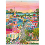 Colorful painting of a small town at sunset with a church, vibrant houses, trees, and a winding road—perfect as the ROSEART-MILLIE ILLUSTRATES-CHARLESTON 300 piece jigsaw puzzle.