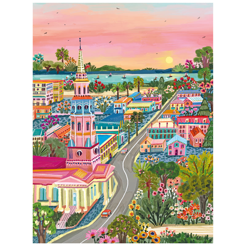 Colorful painting of a small town at sunset with a church, vibrant houses, trees, and a winding road—perfect as the ROSEART-MILLIE ILLUSTRATES-CHARLESTON 300 piece jigsaw puzzle.