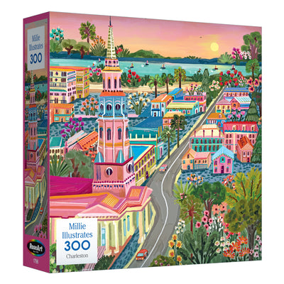 The ROSEART-MILLIE ILLUSTRATES-CHARLESTON-300 PIECE JIGSAW PUZZLE features an illustrated cityscape of Charleston with historic buildings, lush greenery, and a waterfront at sunset.