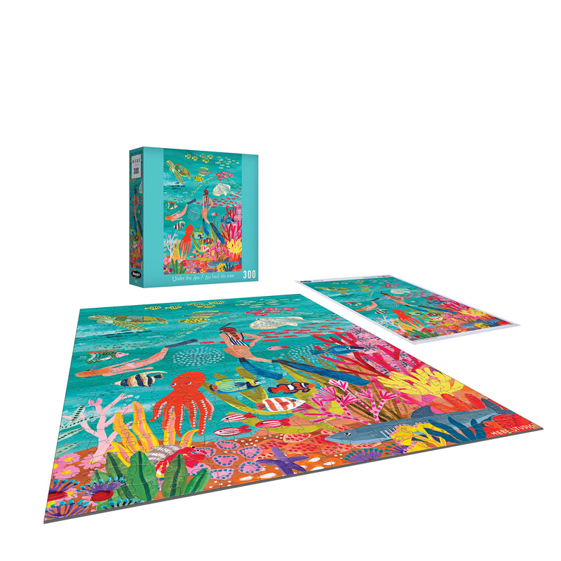 Explore ocean wonders with the ROSEART-HEBE STUDIOS-UNDER THE SEA-300 PIECE JIGSAW PUZZLE, showcasing a lively marine scene. Display the finished puzzle with its box—perfect for family fun or gifting!.