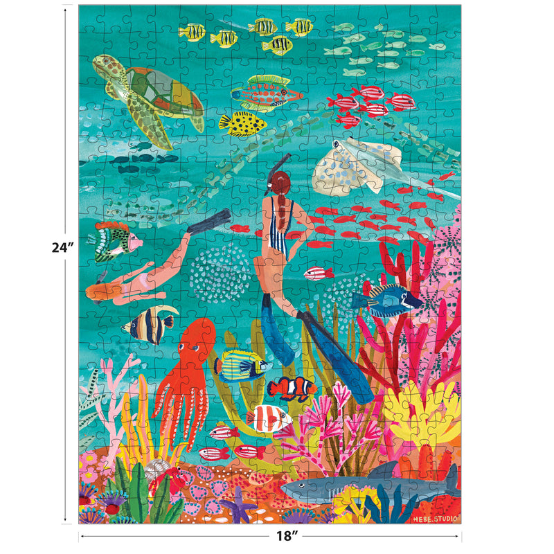 Colorful illustration of two snorkelers with fish, sea turtle, coral, and plants in clear blue water. ROSEART-HEBE STUDIOS-UNDER THE SEA 300 piece jigsaw puzzle, measures 24x18 inches.