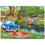 Families boat, tube, and picnic by a river while ducks swim and a classic car and camper add charm—captured in the ROSEART-BIGELOW ILLUSTRATIONS-GOOD TIMES AT THE RIVER-500 PIECE JIGSAW PUZZLE.