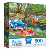 The ROSEART-BIGELOW ILLUSTRATIONS-GOOD TIMES AT THE RIVER 500-piece jigsaw puzzle features a vintage car, picnic scene, and people boating and swimming by a scenic river in a classic Bigelow illustration.
