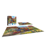 The ROSEART-BIGELOW ILLUSTRATIONS-CANYON EXPRESS 500-piece jigsaw puzzle, completed, showcases a vibrant train scene alongside its box and reference sheet.