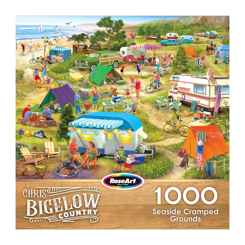 The ROSEART-BIGELOW COUNTRY-SEASIDE CRAMPED GROUNDS-1000 PIECE JIGSAW PUZZLE features an illustration of a busy seaside campground with tents, RVs, and people by the ocean.