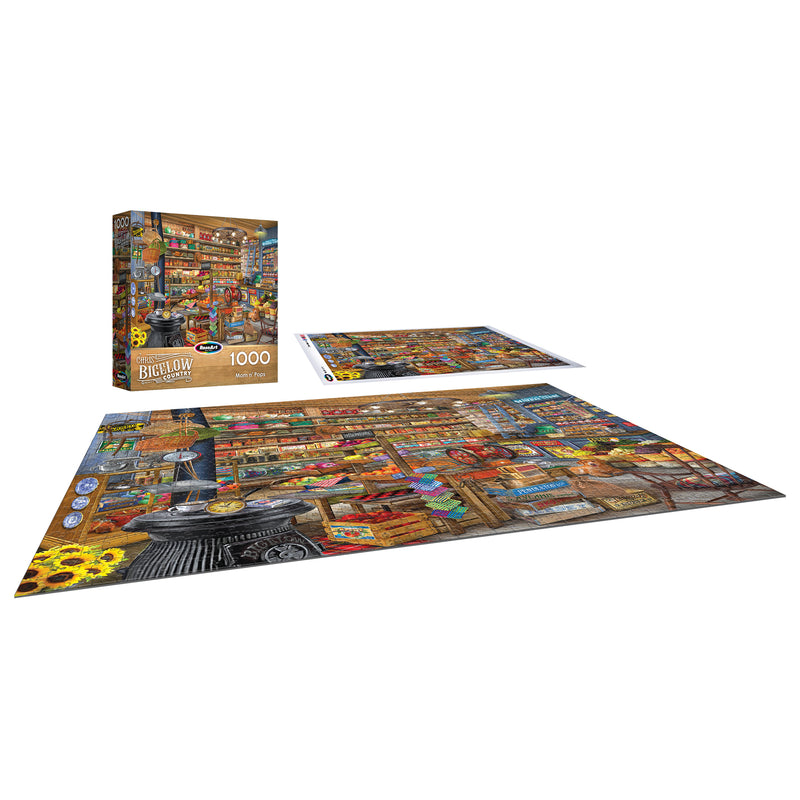The completed ROSEART-BIGELOW COUNTRY-MOM AND POPS-1000 PIECE JIGSAW PUZZLE is shown with its box and a flat image of the colorful general store scene artwork.