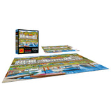 The completed ROSEART-KODAK PREMIUM-LAKE RESORT 1000 piece jigsaw puzzle features a vibrant lake resort scene, with its box and extra pieces shown—ideal for those who love scenic harbor and resort views.
