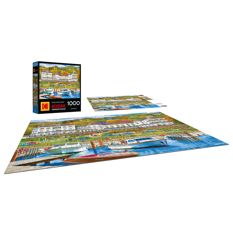 The completed ROSEART-KODAK PREMIUM-LAKE RESORT 1000 piece jigsaw puzzle features a vibrant lake resort scene, with its box and extra pieces shown—ideal for those who love scenic harbor and resort views.
