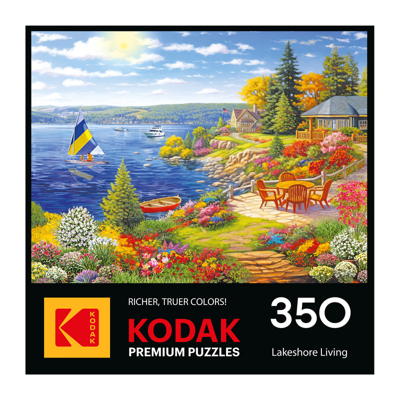 The ROSEART-KODAK PREMIUM "Lakeshore Living" 350-piece jigsaw puzzle features vibrant boats, a sailboat, flowers, and houses by a lake, shown on its colorful box.