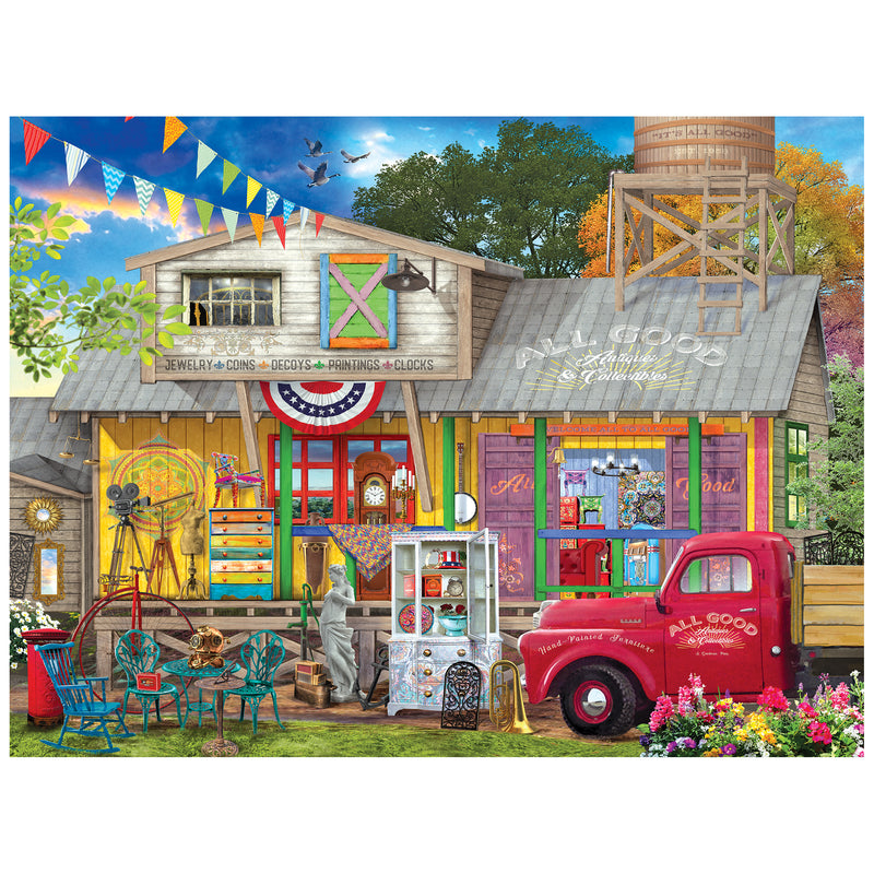 The ROSEART-KODAK PREMIUM: ALL GOOD ANTIQUES 350-piece jigsaw puzzle features a charming vintage shop with antiques, a red pickup, and a wooden water tower—ideal for a nostalgic and inspiring puzzle experience.