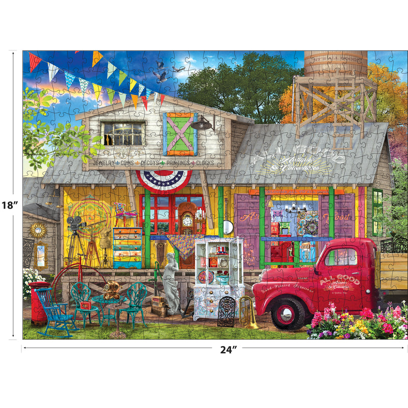 Experience Kodak vibes with the ROSEART-KODAK PREMIUM ALL GOOD ANTIQUES 350-piece jigsaw puzzle, featuring a colorful general store, vintage red truck, outdoor seating, and antiques.