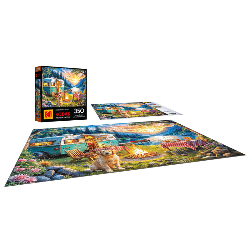 The ROSEART-KODAK PREMIUM "Sunset Camper with Golden Retriever" 350-piece jigsaw puzzle features a vivid campsite scene with a dog, camper, and trees. Both the box and finished puzzle are displayed for an inviting presentation.