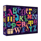 The ROSEART-ALPHABET PUZZLE-500 PIECE JIGSAW PUZZLE features a vibrant alphabet design on a dark background, with each ornately decorated letter—perfect for puzzle enthusiasts and alphabet fans.