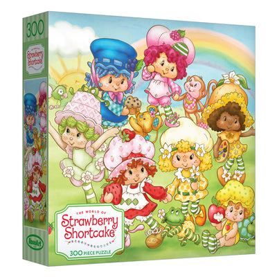 The ROSEART-STRAWBERRY SHORTCAKE-BERRY BESTIES 300-piece jigsaw puzzle showcases Strawberry Shortcake cartoon characters in a lively garden scene filled with flowers, tea sets, and rainbows.