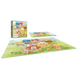 A completed ROSEART-STRAWBERRY SHORTCAKE-BERRY BESTIES-300 PIECE JIGSAW PUZZLE is shown with its box and image guide, featuring colorful cartoon characters on a grassy field.