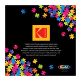 The Kodak logo and vibrant puzzle pieces on a black background showcase the ROSEART-KODAK PREMIUM-THE LAKE HOUSE-350 PIECE JIGSAW PUZZLE, highlighting its superior quality and features.