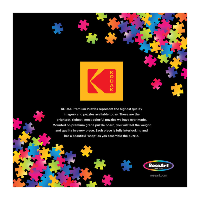 The Kodak logo and vibrant puzzle pieces on a black background showcase the ROSEART-KODAK PREMIUM-THE LAKE HOUSE-350 PIECE JIGSAW PUZZLE, highlighting its superior quality and features.