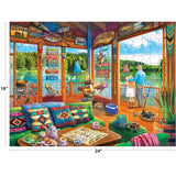Enjoy a vibrant lakeside scene with patterned cushions, tea set, and fishing gear in the ROSEART-KODAK PREMIUM-THE LAKE HOUSE 350 Piece Jigsaw Puzzle (18x24"), featuring sailboats and a fisherman by the water.