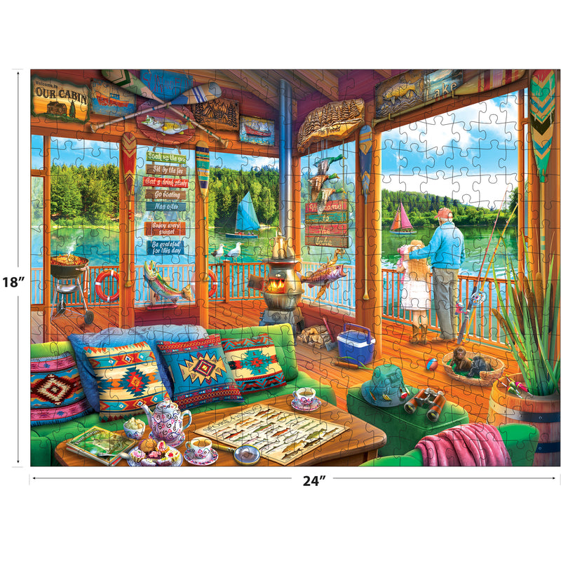 Enjoy a vibrant lakeside scene with patterned cushions, tea set, and fishing gear in the ROSEART-KODAK PREMIUM-THE LAKE HOUSE 350 Piece Jigsaw Puzzle (18x24"), featuring sailboats and a fisherman by the water.