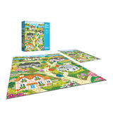 The ROSEART-OLIVIA GIBBS-COASTAL COTTAGE TOWN 300-piece jigsaw puzzle features a vibrant village scene with houses, greenery, and flowers; both the assembled puzzle and its box are displayed.