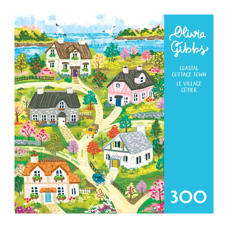 Illustration of a colorful coastal cottage town with winding paths, trees, cars, and houses by the water; "ROSEART-OLIVIA GIBBS-COASTAL COTTAGE TOWN-300 PIECE JIGSAW PUZZLE" celebrates serene seaside living.