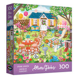 The ROSEART-OLIVIA GIBBS-EASTER GARDEN 300-piece jigsaw puzzle features a vibrant Easter garden with blooming flowers, garden furniture, playful animals, and a charming house in the background.