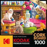 RoseArt - Kodak Cork - Kittens by the Fireplace - 1000 Piece Jigsaw Puzzle: Puzzle box showing a vivid illustration of six kittens playing in a cozy room. The box details a RoseArt - Kodak Cork - Kittens by the Fireplace - 1000 Piece Jigsaw Puzzle, featuring cork board material and mentioning a bonus puzzle poster.