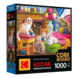 A box containing the 1000-piece RoseArt Kodak Cork jigsaw puzzle titled "Kittens by the Fireplace," which features an image of playful kittens lounging in a lavish, colorfully decorated room.