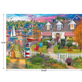 Colorful puzzle featuring a coastal village scene with boats, a house with red awnings, a picket fence, and a vibrant garden. Dimensions of the puzzle are 26.625 inches by 19.25 inches. Product Name: RoseArt - Kodak Cork - Charles Harbor - 1000 Piece Jigsaw Puzzle