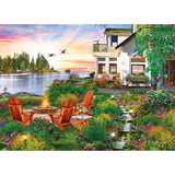 A garden with Adirondack chairs around a fire pit by a lake at sunset resembles the RoseArt - My Happy Place - Harbor House jigsaw puzzle, where birds soar and the Harbor House adds charm and tranquility.