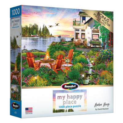 Experience relaxation with the ROSEART "MY HAPPY PLACE - HARBOR HOUSE" 1000-piece jigsaw puzzle, featuring a tranquil lakeside scene with a house, chairs by a fire pit, trees, and a stunning sunset.