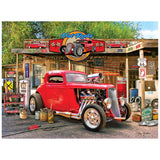 The ROSEART American Nostalgia Hot Rod Gas Up 550 Piece Jigsaw Puzzle features a classic red hot rod at a retro garage with vintage signs and pumps, evoking timeless American charm.