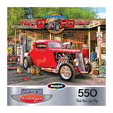 A red vintage hot rod is parked at a retro gas station with nostalgic decor in the ROSEART "American Nostalgia - Hot Rod Gas Up" 550-piece jigsaw puzzle.