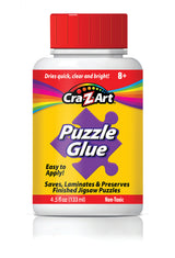 A bottle of RoseArt - 4.5 oz Puzzle Glue 6 pack with a red cap. The label states it is easy to apply, non-toxic, and intended for saving, laminating, and preserving finished jigsaw puzzles. Contains 4.5 fl oz (133 ml).