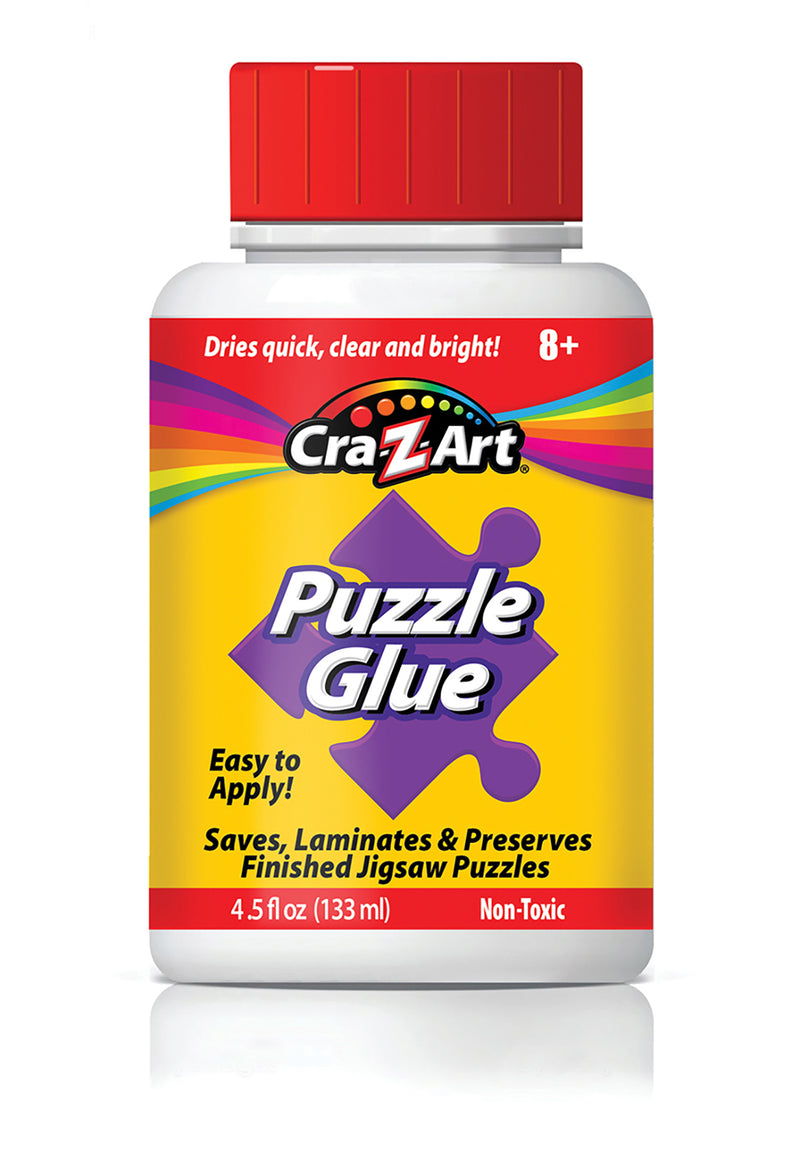 A bottle of RoseArt - 4.5 oz Puzzle Glue 6 pack with a red cap. The label states it is easy to apply, non-toxic, and intended for saving, laminating, and preserving finished jigsaw puzzles. Contains 4.5 fl oz (133 ml).
