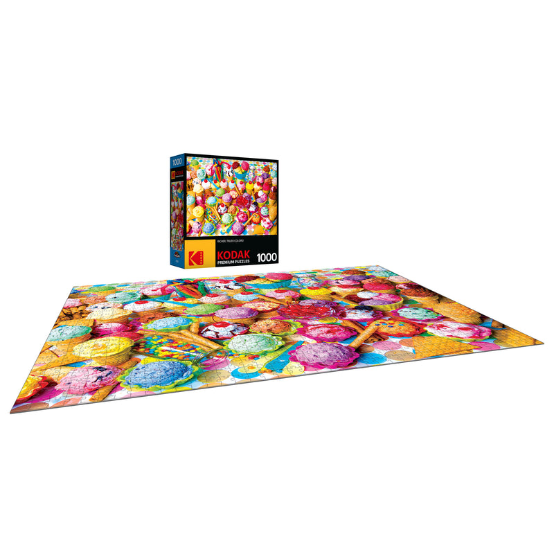A completed jigsaw puzzle with a colorful assortment of macarons, shown with its 1000-piece RoseArt - Kodak Premium - Variety of Colorful Ice Cream - Jigsaw Puzzle.