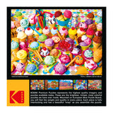 A brightly colored jigsaw puzzle image featuring an assortment of ice cream scoops in cones and bowls, surrounded by various toppings and sweets. Text and brand logo appear below the puzzle image. RoseArt - Kodak Premium - Variety of Colorful Ice Cream - 1000 Piece Jigsaw Puzzle.