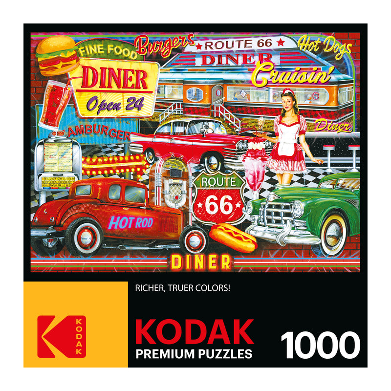 A RoseArt - Kodak Premium - 50's Diner - 1000 Piece Jigsaw Puzzle depicting a colorful diner scene with retro cars, neon signs, a waitress, burgers, hot dogs, and Route 66 references.
